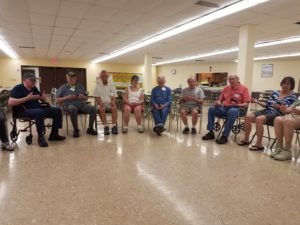 seniors seated while practicing group mindfulness meditation