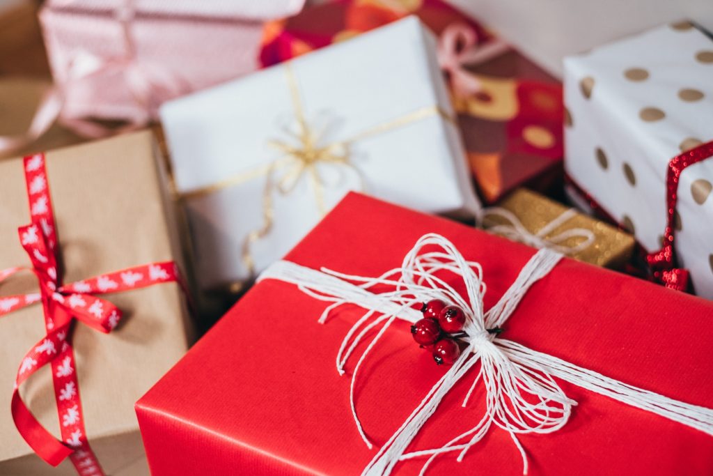 Christmas gifts wrapped in red, gold and white paper 